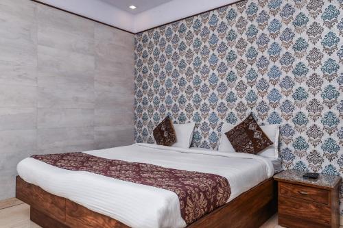 1 dormitorio con cama y pared en Hotel Dream Palace Laxmi Nagar, en Nueva Delhi