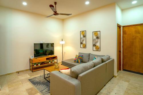 a living room with a couch and a flat screen tv at Condo Rosales Beautiful Downtown 2BR-1Ba with pool & rooftop in La Paz