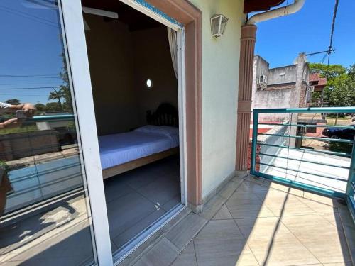a room with a bed on a balcony at Dpto 2 dormitorios de Lujo in Bella Vista