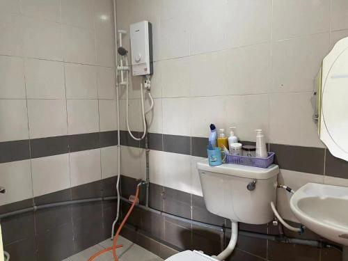 een badkamer met een toilet en een wastafel bij Sibu Homestay Happy Family in Sibu