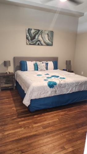 a bedroom with a large bed with blue and white sheets at Trendy Midtown Lofts in Cleveland