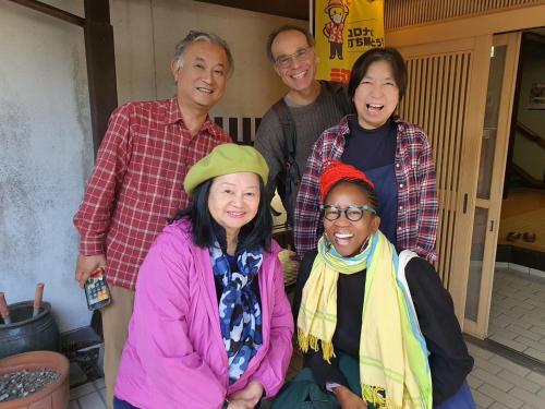 a group of people posing for a picture at Family Ryokan Kawakyu with Showa Retro, private hot spring in Ibusuki