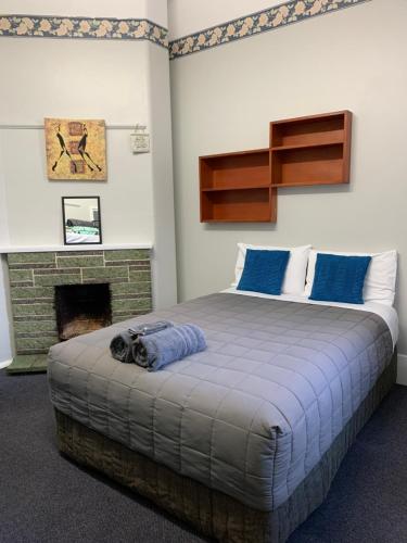 a bedroom with a bed with a dog laying on it at Thomas's Catlins Lodge and Camp Ground in Owaka