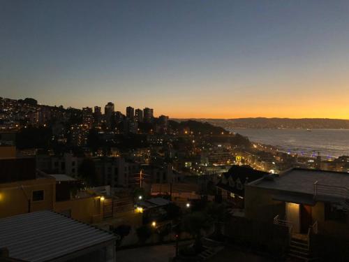 a view of a city at night with the water at FINTUPS SPA in Viña del Mar