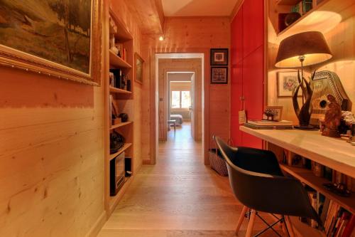 a home office with red walls and a desk and chairs at Dents Du Midi 54, The Sunny Attic in Champéry