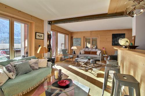 a living room with a couch and a table at Dents Du Midi 54, The Sunny Attic in Champéry