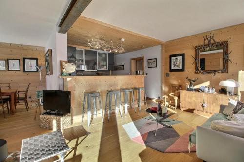 a living room with a kitchen and a bar at Dents Du Midi 54, The Sunny Attic in Champéry