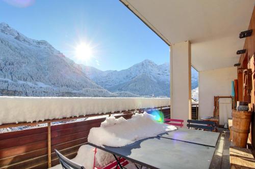 a balcony with a table and a view of mountains at Dents Du Midi 54, The Sunny Attic in Champéry