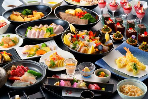 a table filled with many different types of food at Grandvrio Hotel Beppuwan Wakura - ROUTE INN HOTELS - in Beppu