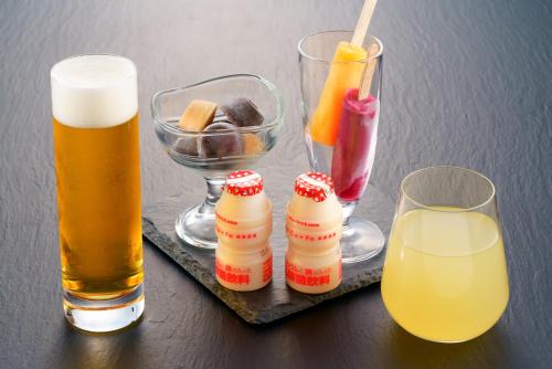 a table with a tray with two glasses of beer at Grandvrio Hotel Beppuwan Wakura - ROUTE INN HOTELS - in Beppu
