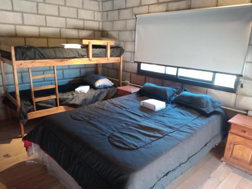 a room with two bunk beds and a whiteboard at LOS ALTOS DE SAN JACINTO 2 in Mar del Plata