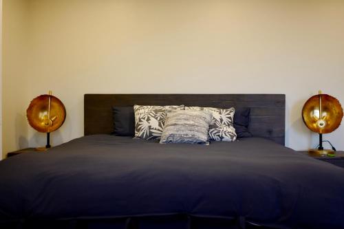 a bedroom with a large bed with two lamps at Hollywood Hills Haven-Guest House in Los Angeles