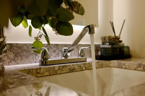 a bathroom sink with water coming out of a faucet at Hollywood Hills Haven-Guest House in Los Angeles