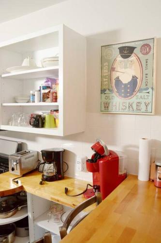 a kitchen with a counter and a desk with a coffee maker at Square Toe's Last Resort in New Buffalo