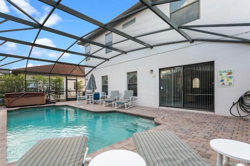 a swimming pool with a glass roof over it at Paradise Resort Styles 4 BEDROOMS with 3 baths Pool and SPA in Orlando