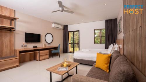 a hotel room with a bed and a couch at Damai Laut Escape by Perfect Host in Lumut