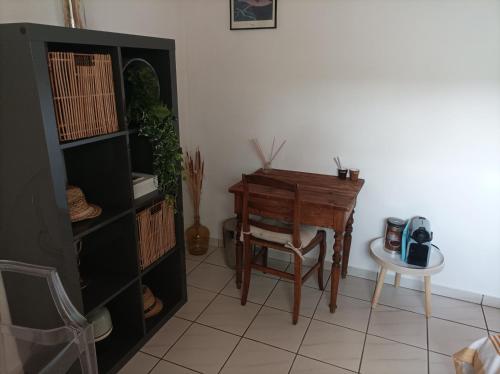 メリニャックにあるChambre cosy et salle d'eau dans maison Mérignac Arlacのデスク、椅子、テーブルが備わる客室です。