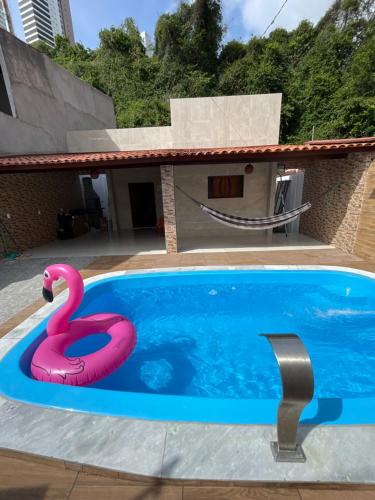 a pink swan float in a swimming pool at Casa de Férias á 400m pra Praia de Cabo Branco in João Pessoa