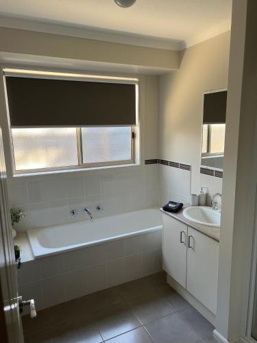 a bathroom with a bath tub and a sink at Beach Haven in Rosebud
