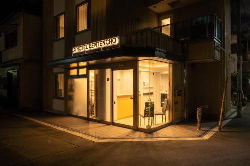 a store front of a building at night at JA Hotel Bentencho 弁天町 in Osaka