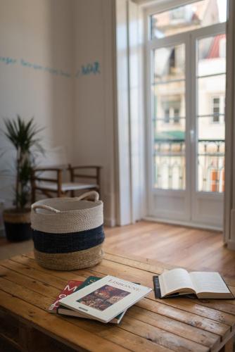 a table with books and a basket and a book at Lisbon Story Guesthouse in Lisbon