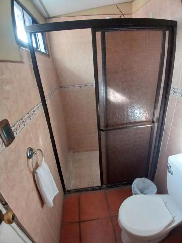 a bathroom with a shower and a toilet at Loma Alta Home in Santa Ana