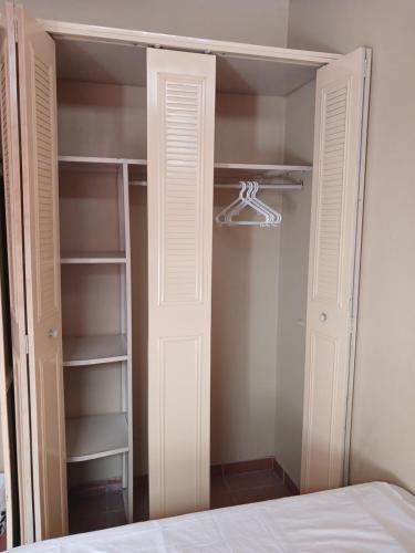 a closet with a white door and a hanger at Loma Alta Home in Santa Ana