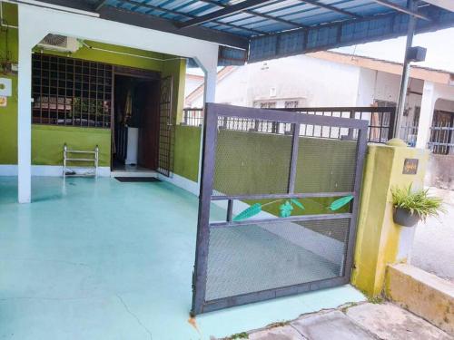 an open door of a building with a gate at Syukur Homestay Ipoh in Ipoh