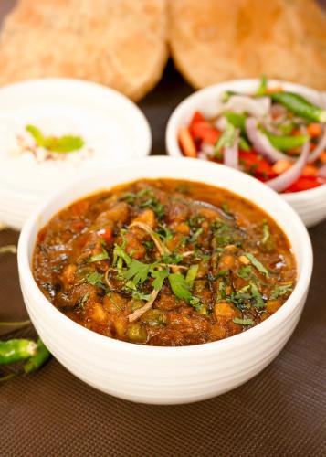 a bowl of soup with a salad and some bread at Hyatt Place Bodh Gaya in Bodh Gaya