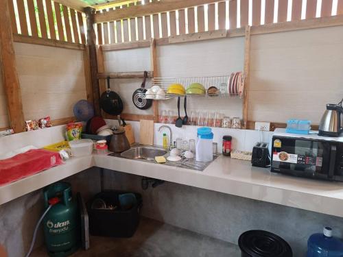a kitchen with a sink and a counter top at LANTA LUCKY HOUSE in Ko Lanta