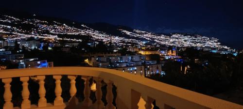 a view of a city lit up at night at Casa Alencastre in Funchal