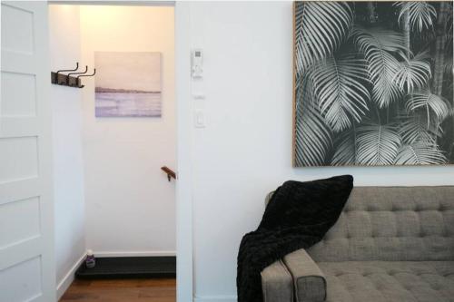 a living room with a couch and a painting on the wall at HRésidences Modern Condo on MAIN St Laurent Blvd in Montréal