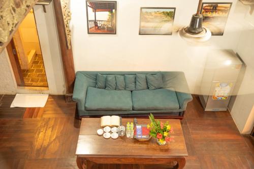 a living room with a blue couch and a coffee table at Full Moon Beach Resort in Mui Ne