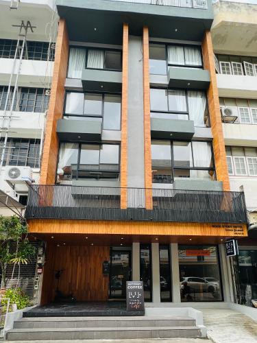 a building with a sign in front of it at Woodstory Boutique Hotel in Bangkok