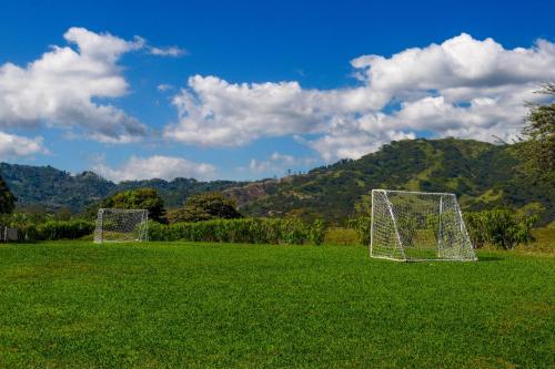 two soccer goals in a field with mountains in the background at Finca de La Luna in Atenas