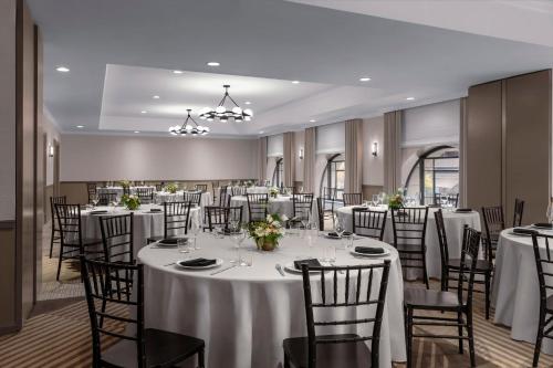a banquet room with white tables and chairs at Kimpton Hotel Monaco Salt Lake City by IHG in Salt Lake City