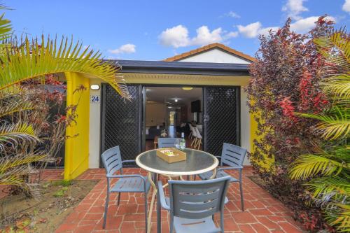 a table and chairs on a brick patio at Villa 24 in Elliott Heads