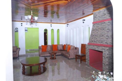 a living room with a couch and a fireplace at Esniko Villa in Narok