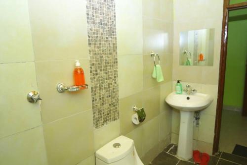 a bathroom with a toilet and a sink at Esniko Villa in Narok