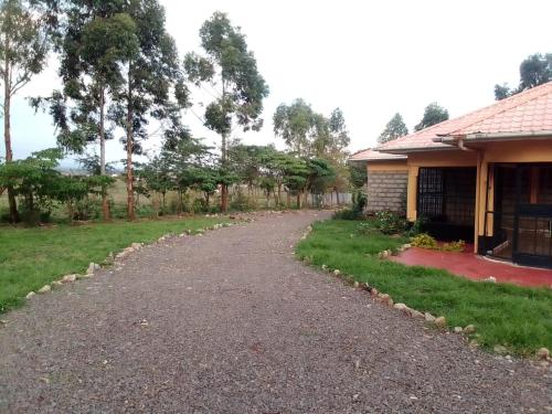 a gravel driveway next to a house at Esniko Villa in Narok