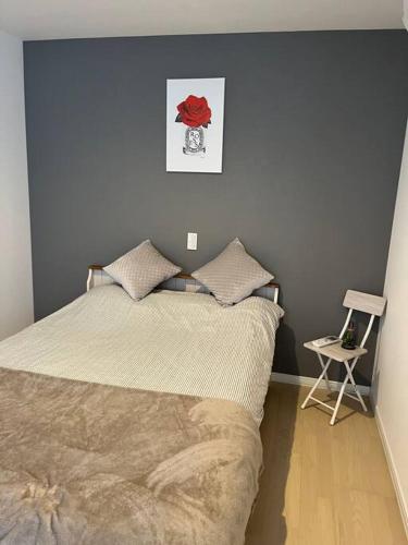 a bedroom with a bed with a red rose on the wall at 福偉亭 in Otaru