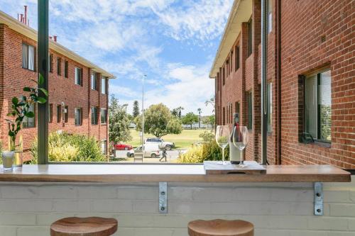 a bar with two stools and a view of a street at Langley Park 2BR CBD Character Apt with FREE Parking in Perth