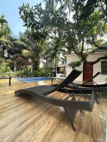 a hammock sitting on top of a wooden floor at SUN 4BHK VILLA ALIBAUG in Alibaug