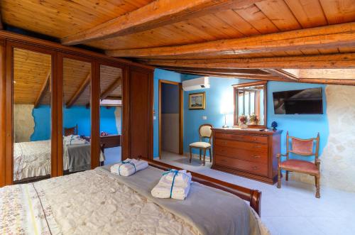 a bedroom with a bed and a dresser and a desk at Casa delle Zammare Fronte mare centro storico in Riposto