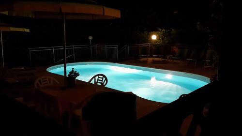 a swimming pool in the dark at night at Hotel Garden Ristorante in Tabiano