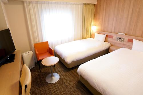 Ένα ή περισσότερα κρεβάτια σε δωμάτιο στο Daiwa Roynet Hotel Osaka Yotsubashi