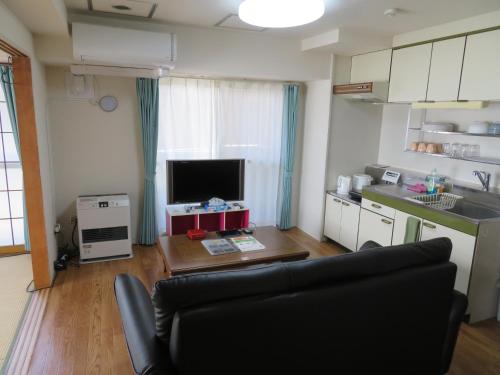 a living room with a couch and a table at 札幌市中心部大通公園まで徒歩十分観光移動に便利なロケーションh208#16B in Sapporo