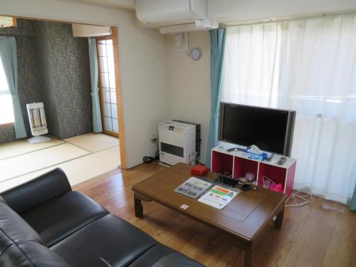 a living room with a couch and a coffee table at 札幌市中心部大通公園まで徒歩十分観光移動に便利なロケーションh208#16B in Sapporo