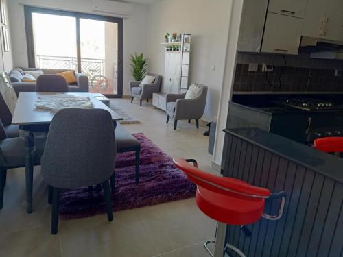a living room with a table and chairs at Fully furnished - 80 mt in Celia compound in new administrative city in Cairo