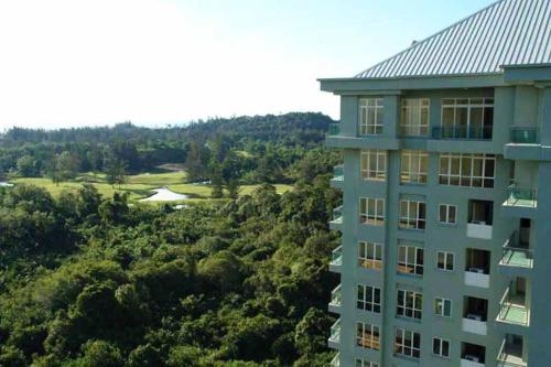 a building with a view of a golf course at The Apartment at Santubong in Kuching
